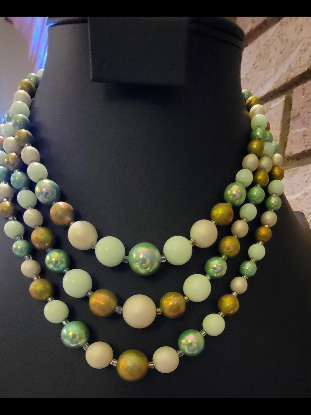 Vintage, triple-strand necklace features graduated beads in shades of green
